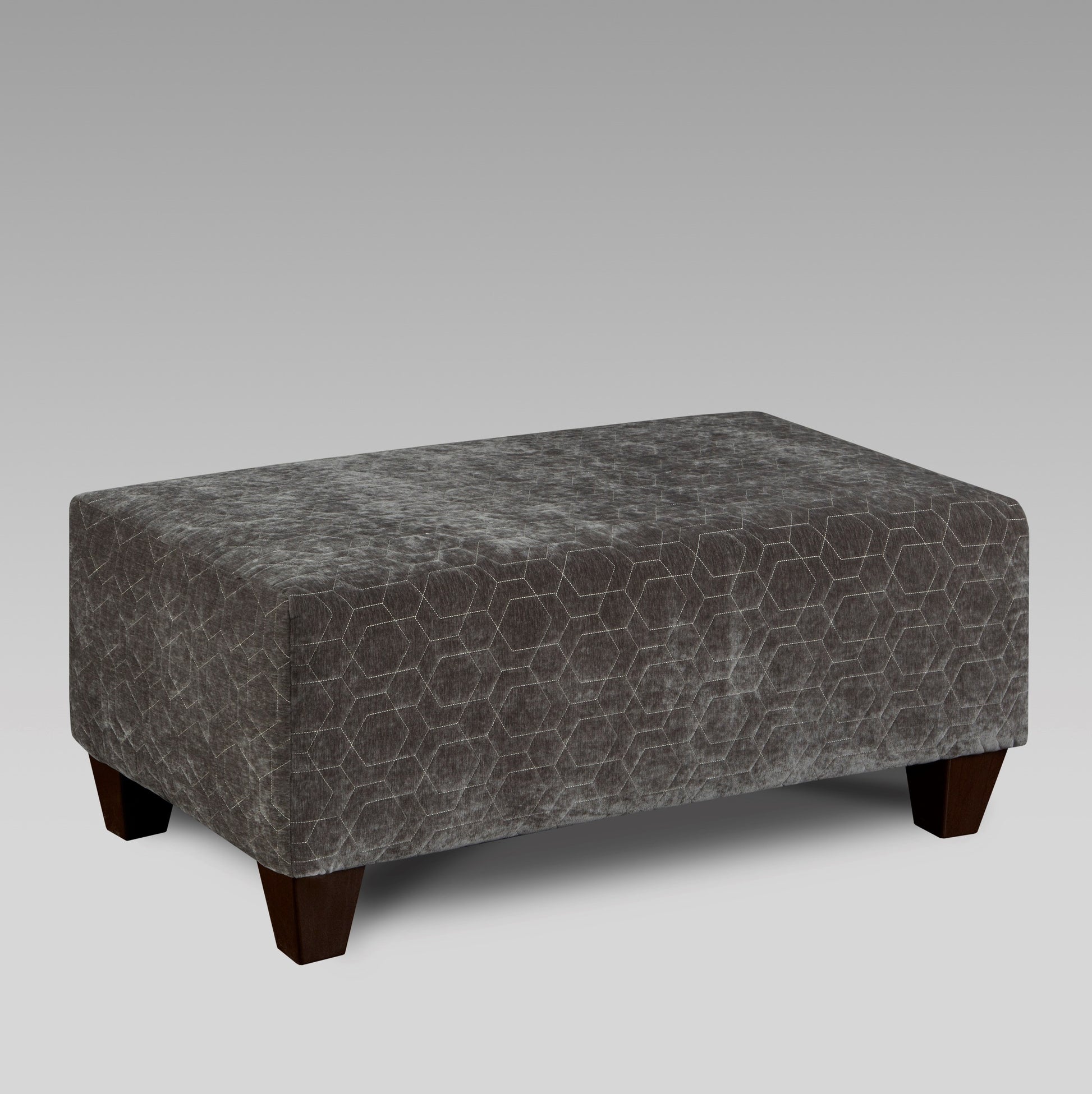 Dark gray velvet ottoman with hexagonal stitching and dark wood legs
