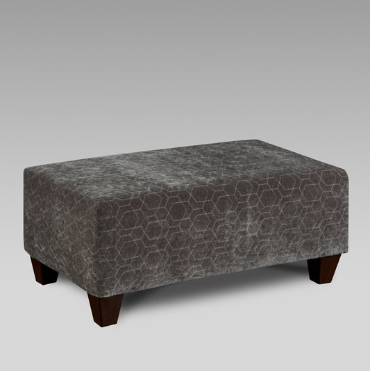 Dark gray velvet ottoman with hexagonal stitching and dark wood legs