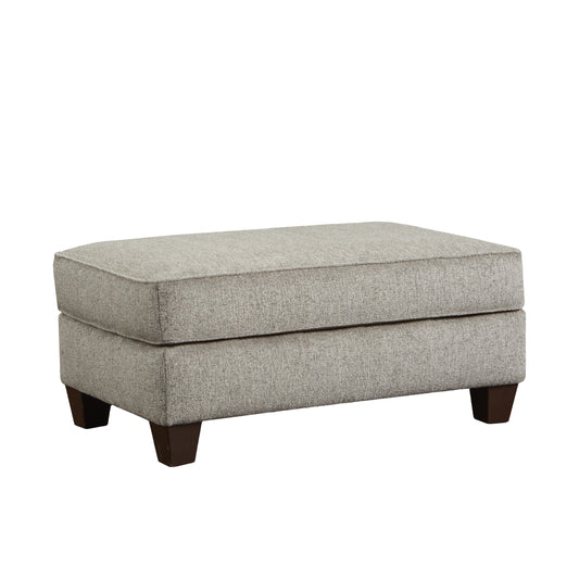 Light gray textured fabric ottoman with dark wooden block legs perfect for a living room accent
