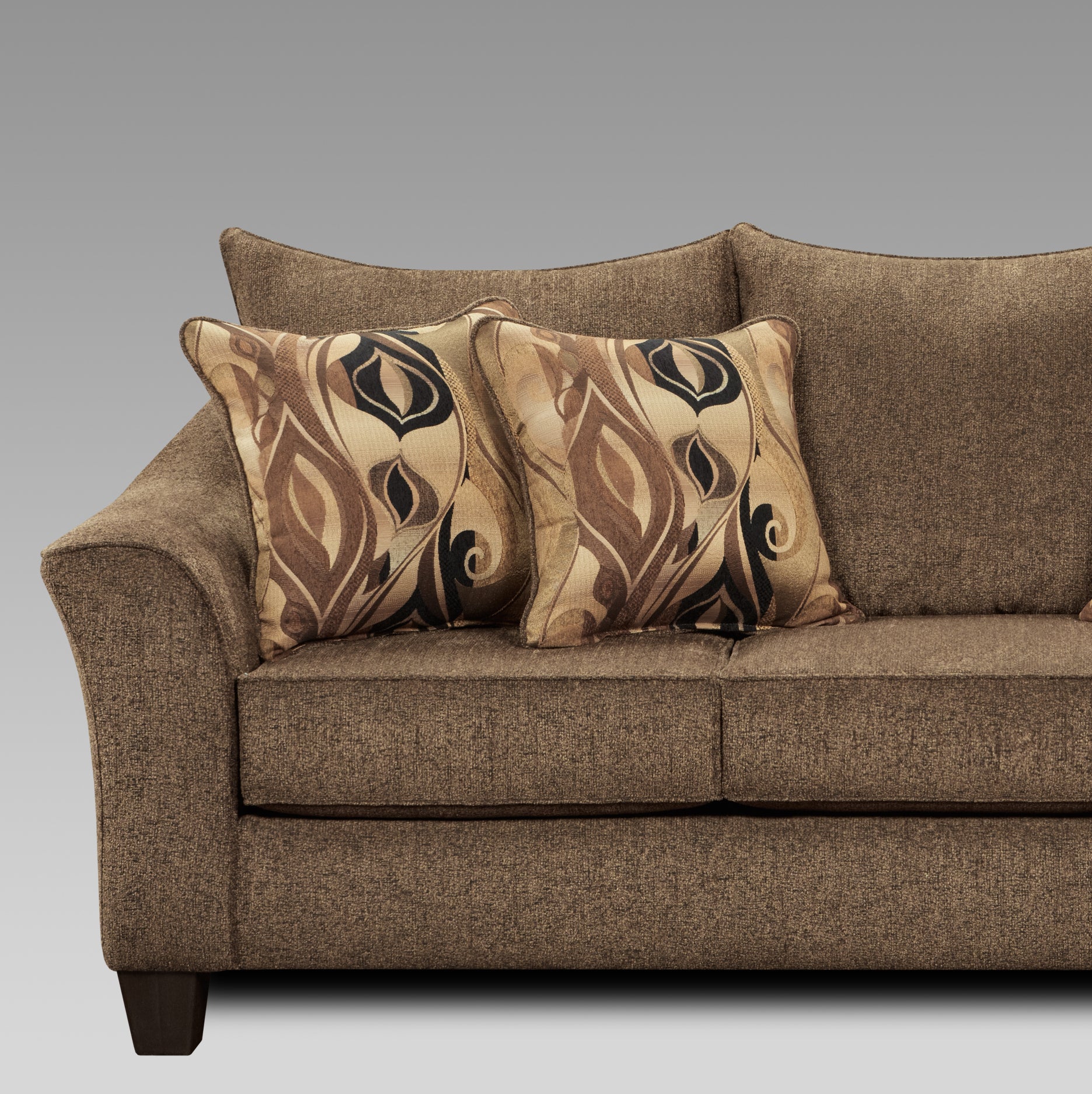 Brown textured fabric sofa with two patterned throw pillows for comfortable living room seating