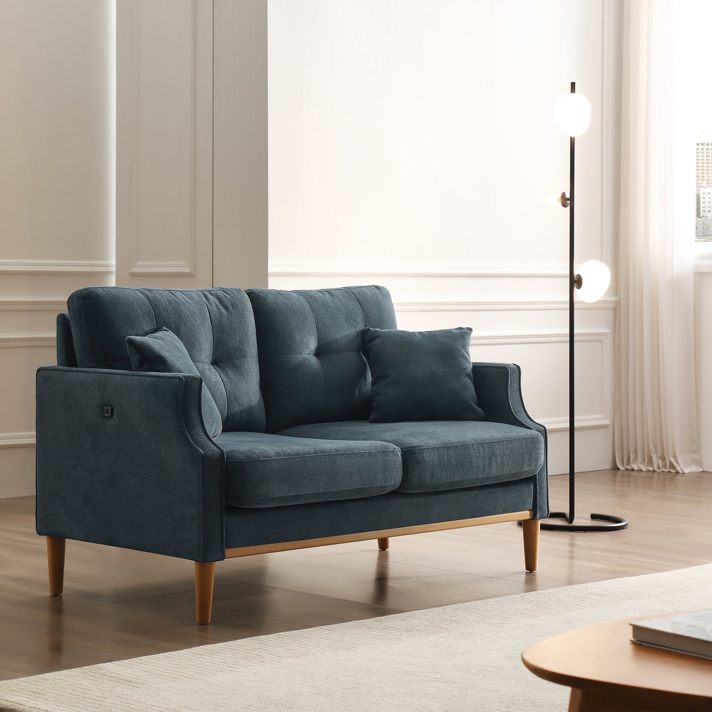 Blue fabric loveseat with tufted back cushions and wooden legs