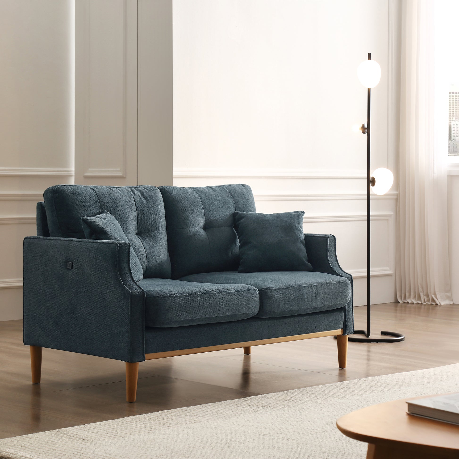 Blue fabric loveseat with tufted back cushions and wooden legs