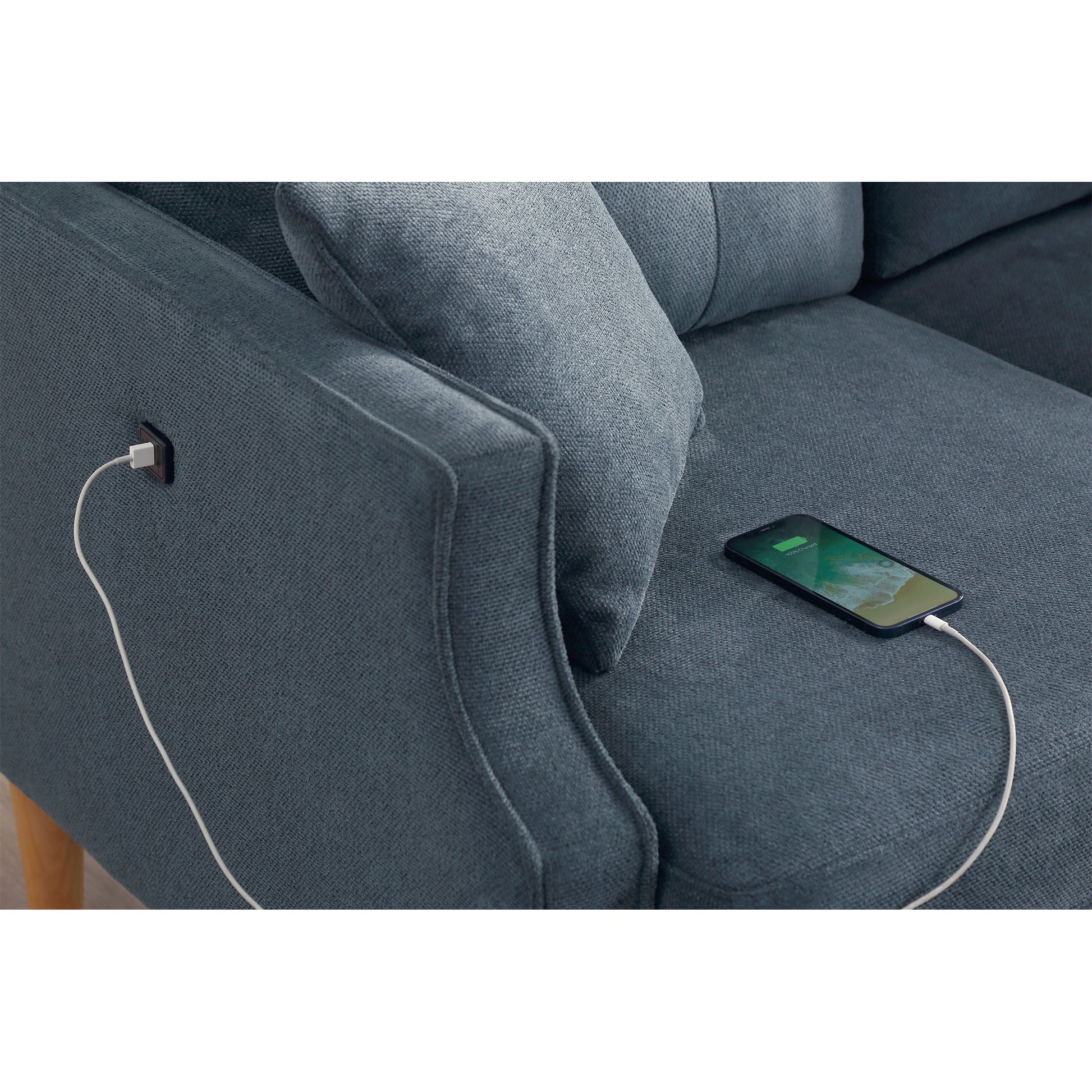 Blue fabric couch with integrated USB charging port for devices