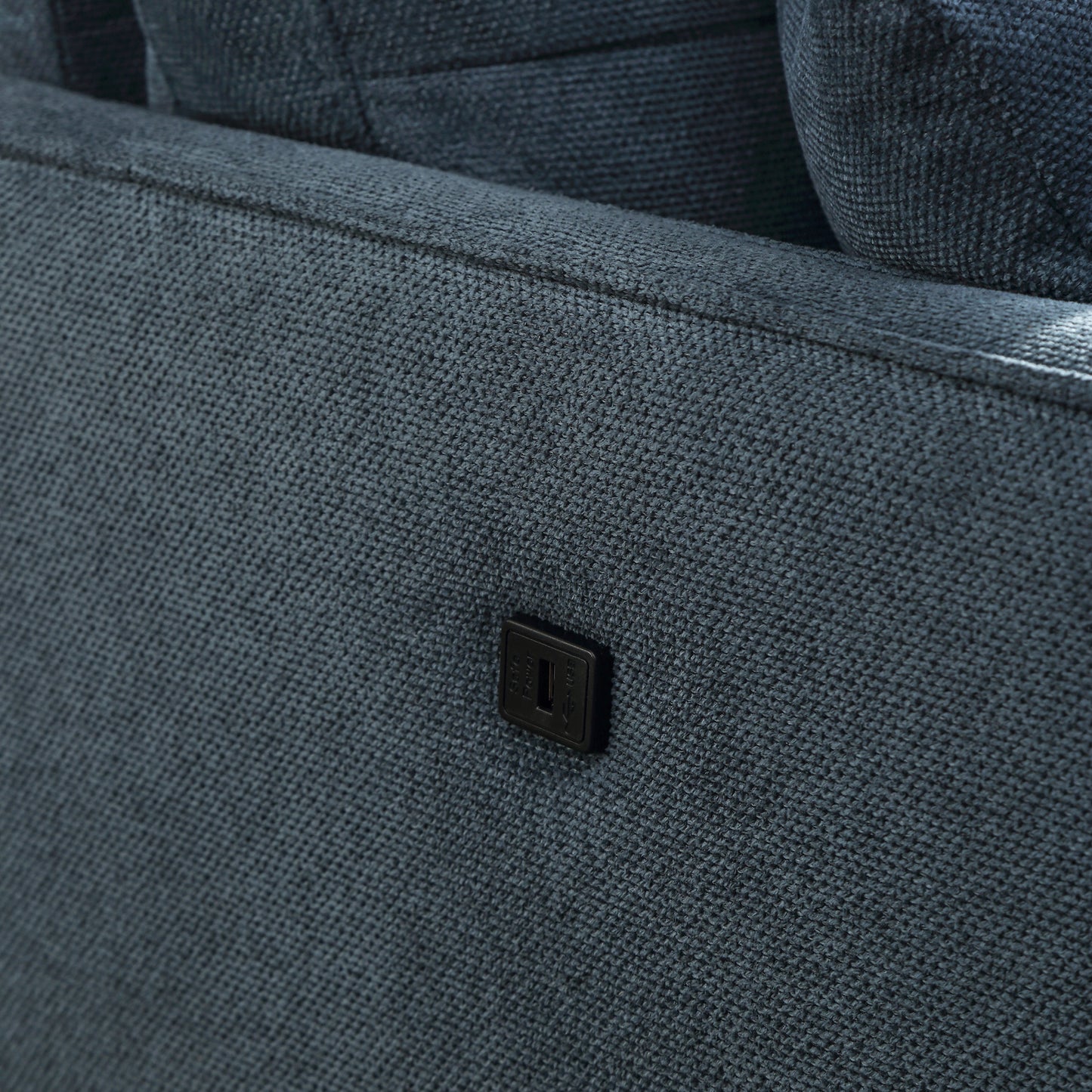 Dark grey fabric sofa with integrated USB power port for charging devices