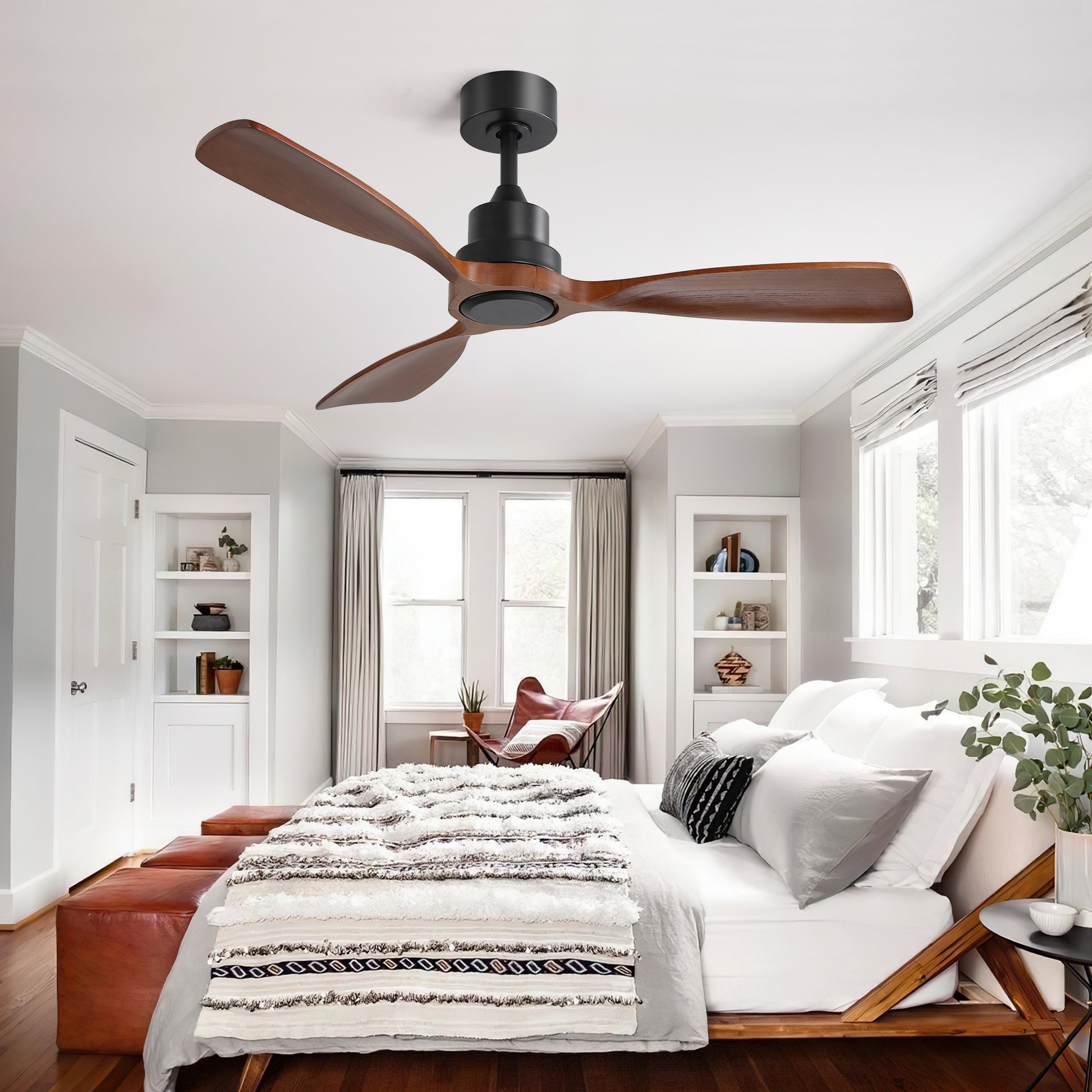 Modern black ceiling fan with three natural wood blades in a bedroom