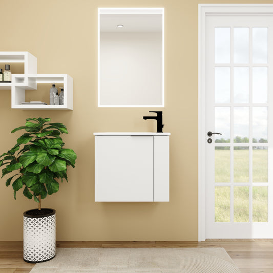 Modern white bathroom vanity with black faucet and illuminated mirror
