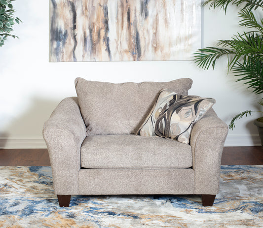 Taupe fabric accent chair with plush back cushions and decorative pillow