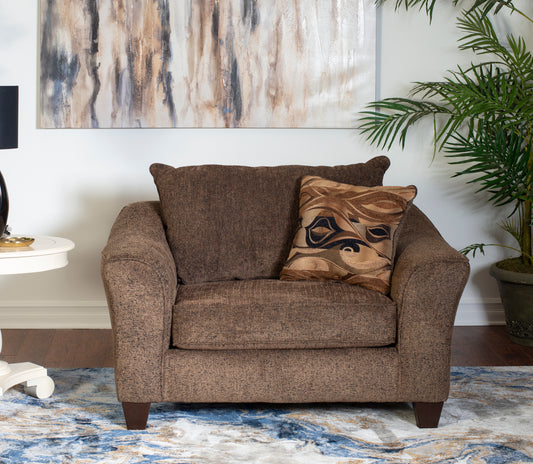 Brown textured accent chair with a decorative throw pillow