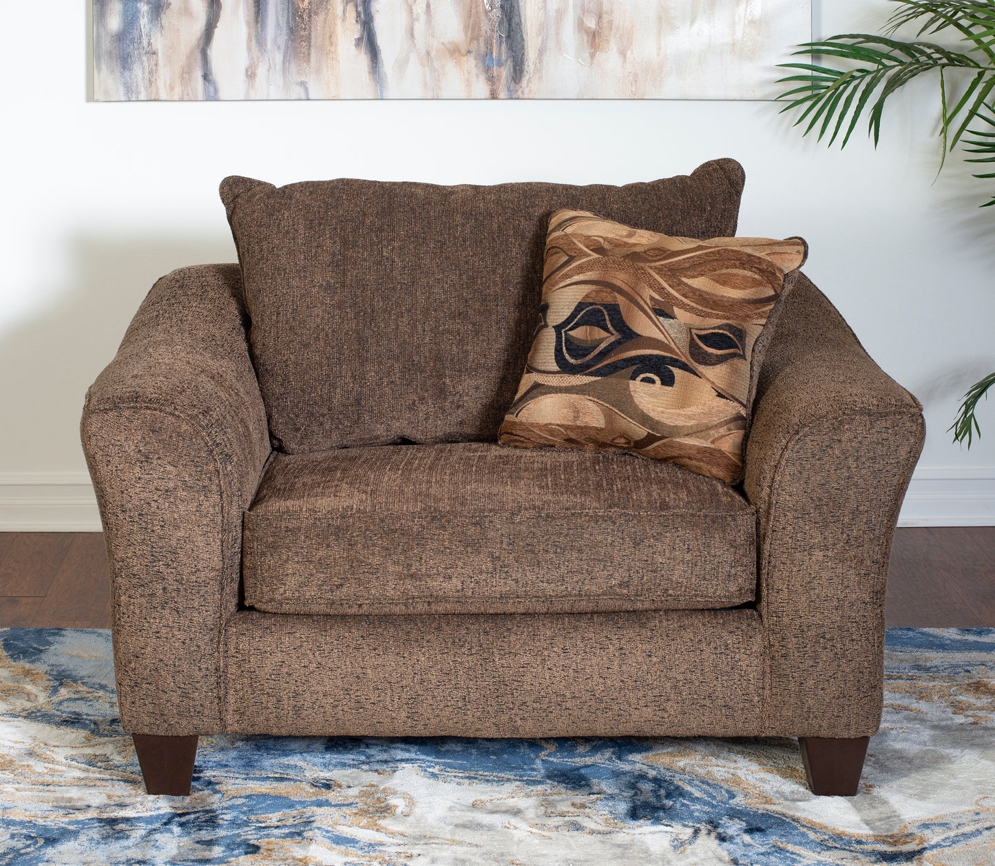 Brown textured armchair with a patterned throw pillow