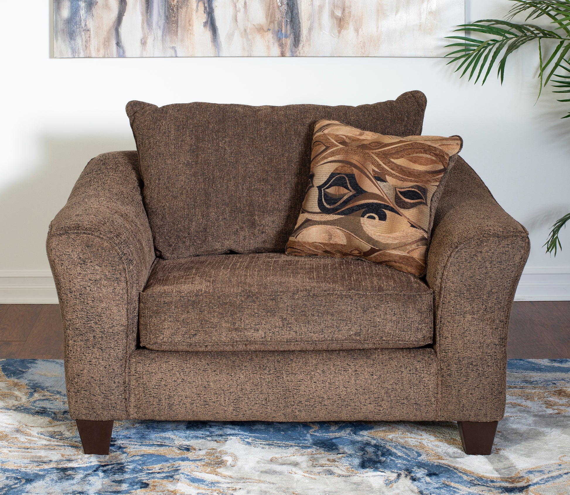 Brown textured armchair with a patterned throw pillow