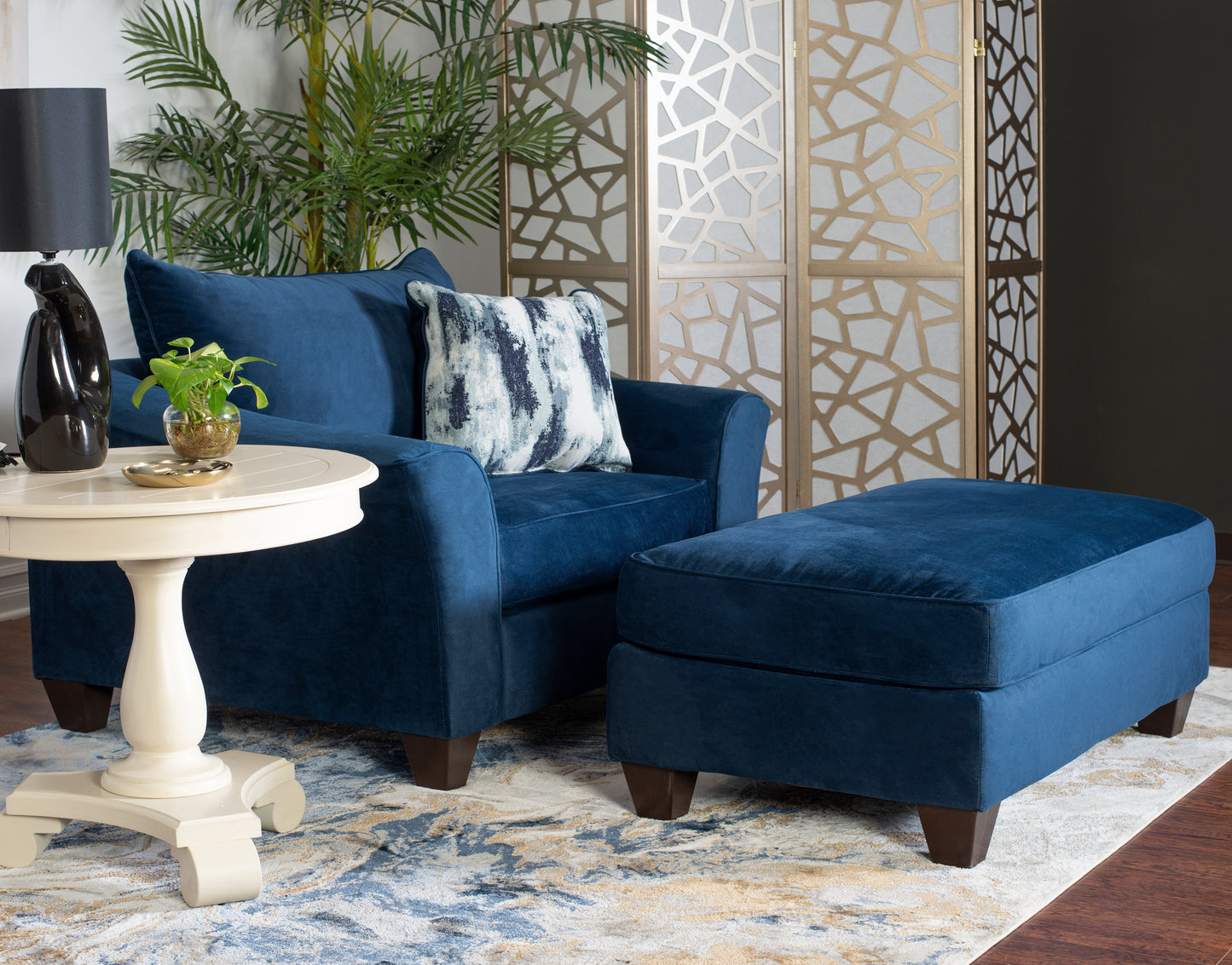 Plush blue velvet armchair with matching ottoman perfect for relaxing