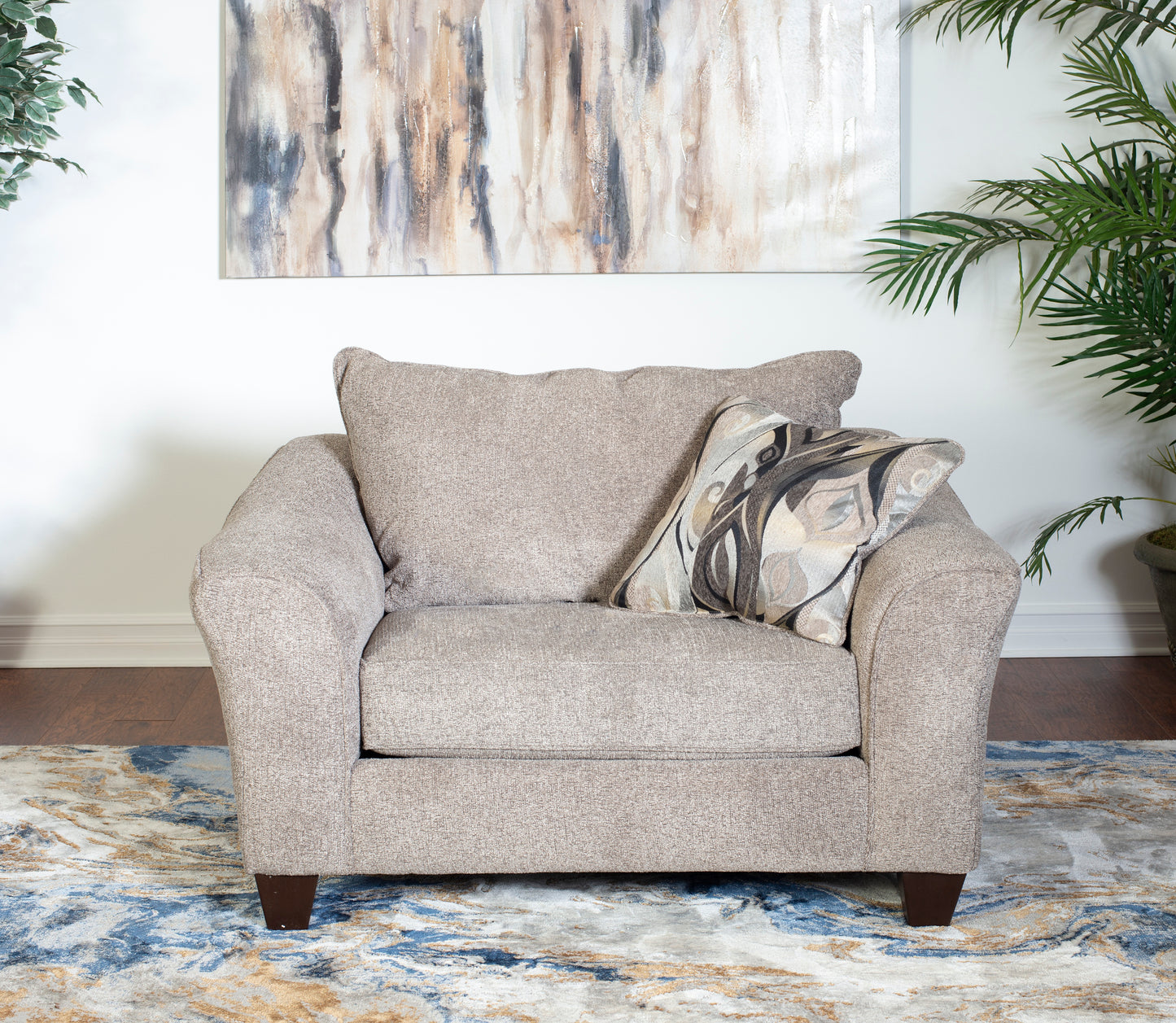 Comfortable beige fabric armchair with a decorative accent pillow perfect for living rooms
