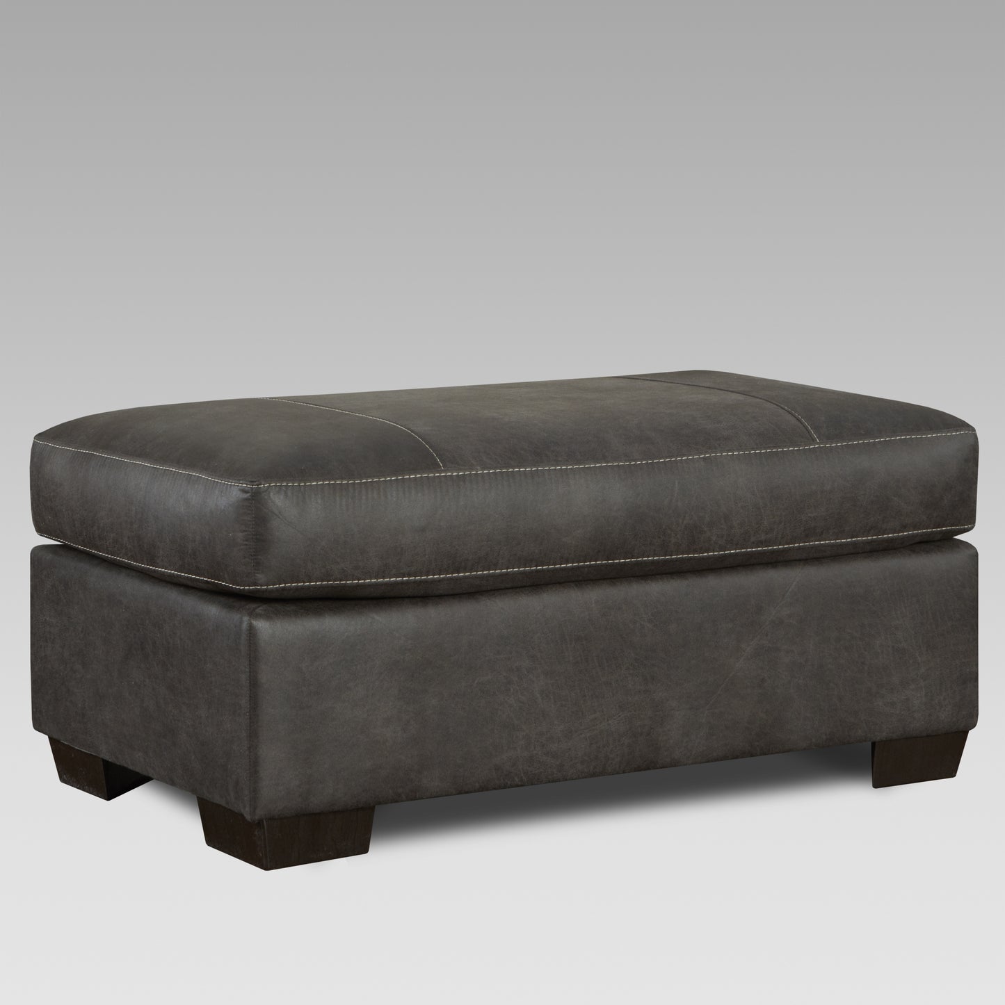 Dark grey faux leather ottoman with white stitching and dark wood legs
