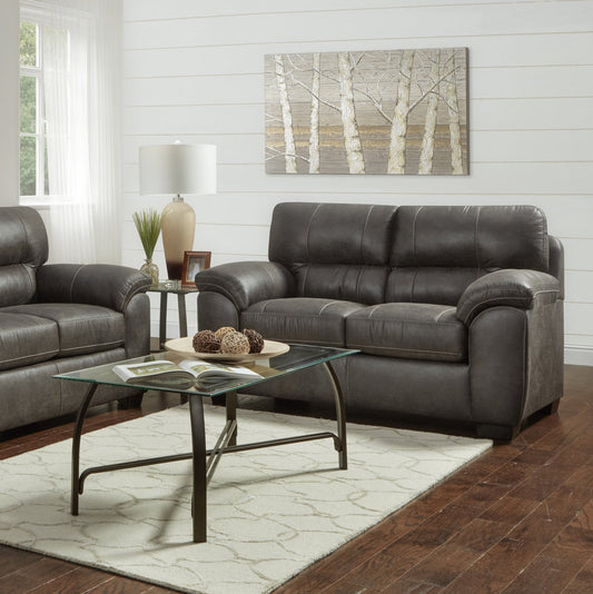 Gray leather loveseat with stitching details and plush cushions perfect for a living room