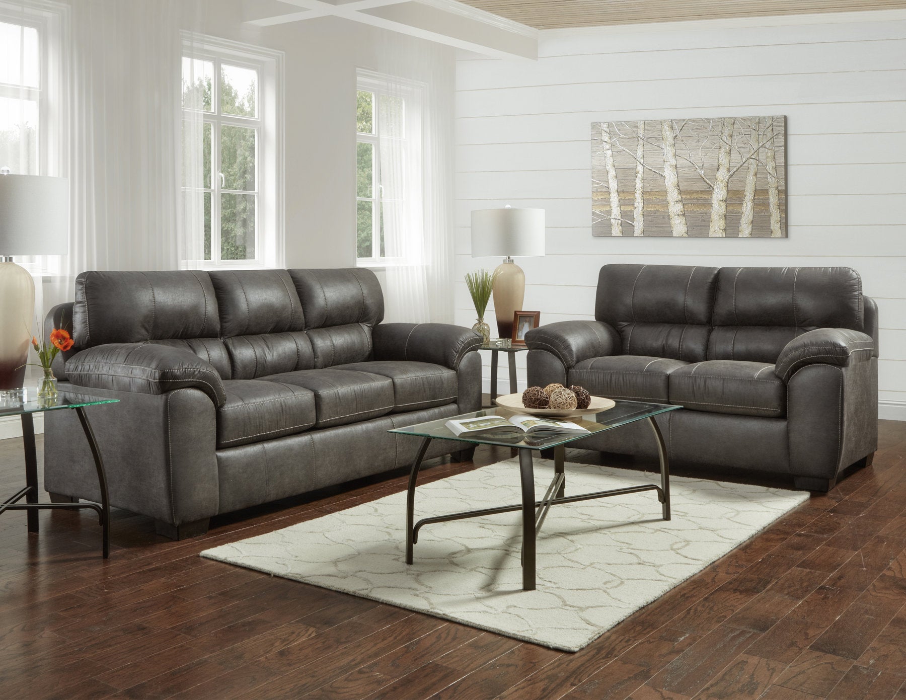 Dark charcoal faux leather sofa with contrast stitching a classic living room centerpiece