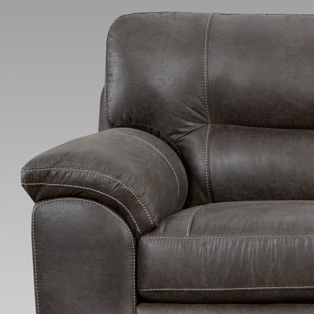 Close up of a plush brown leather recliner with detailed stitching accentuating comfort and quality