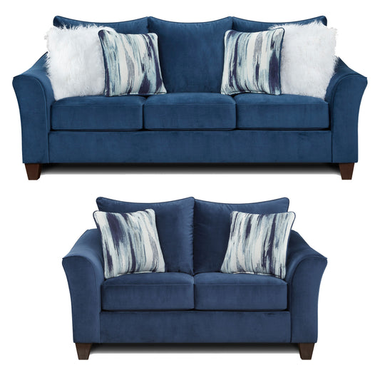 Plush navy blue velvet sofa with decorative abstract pattern throw pillows and white faux fur accent pillows