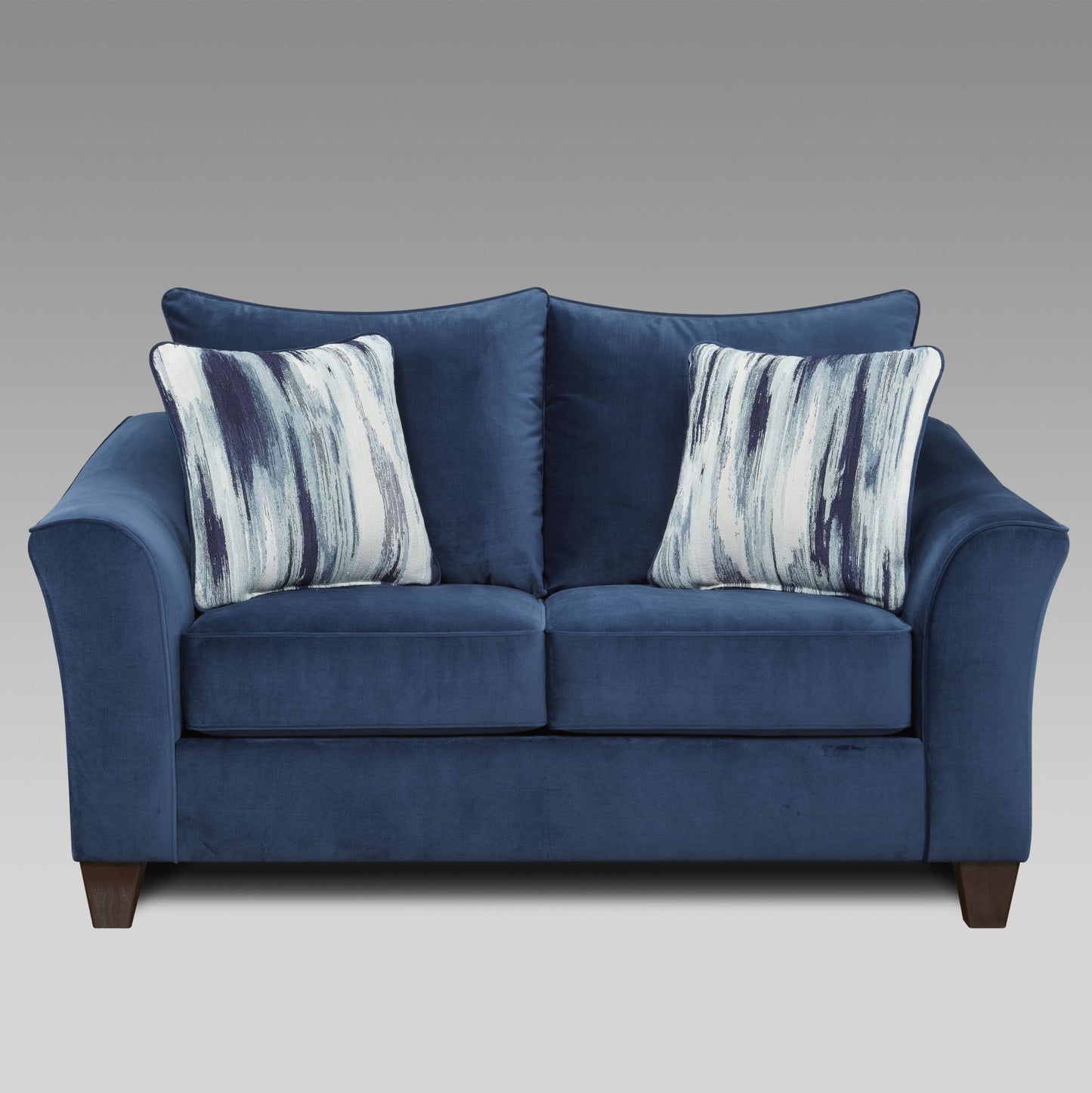 Navy blue velvet loveseat with abstract blue and white throw pillows
