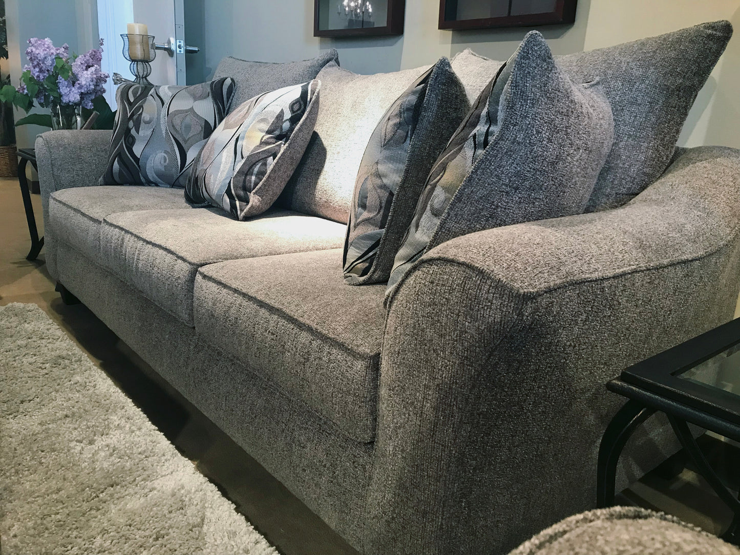 Gray textured fabric sofa with decorative pillows and matching throw pillows for living room comfort