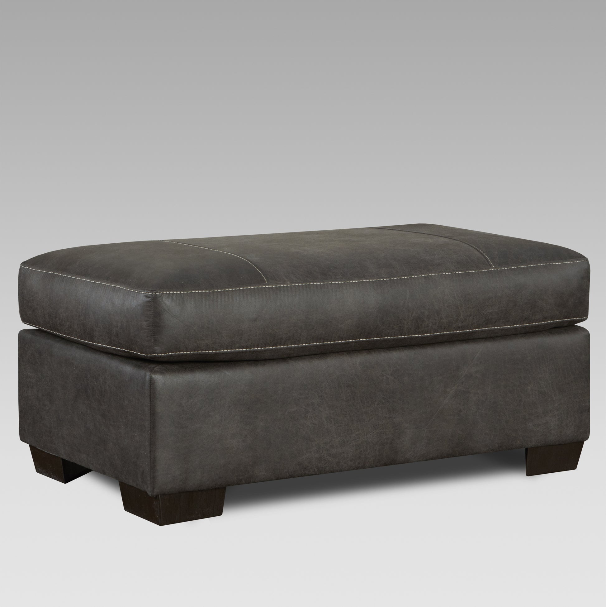 Dark grey rectangular leather ottoman with white stitching accents and wooden feet