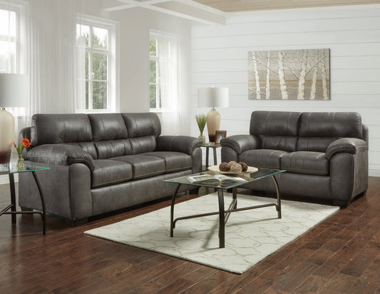 Dark grey leather sofa set with detailed stitching and plush cushions