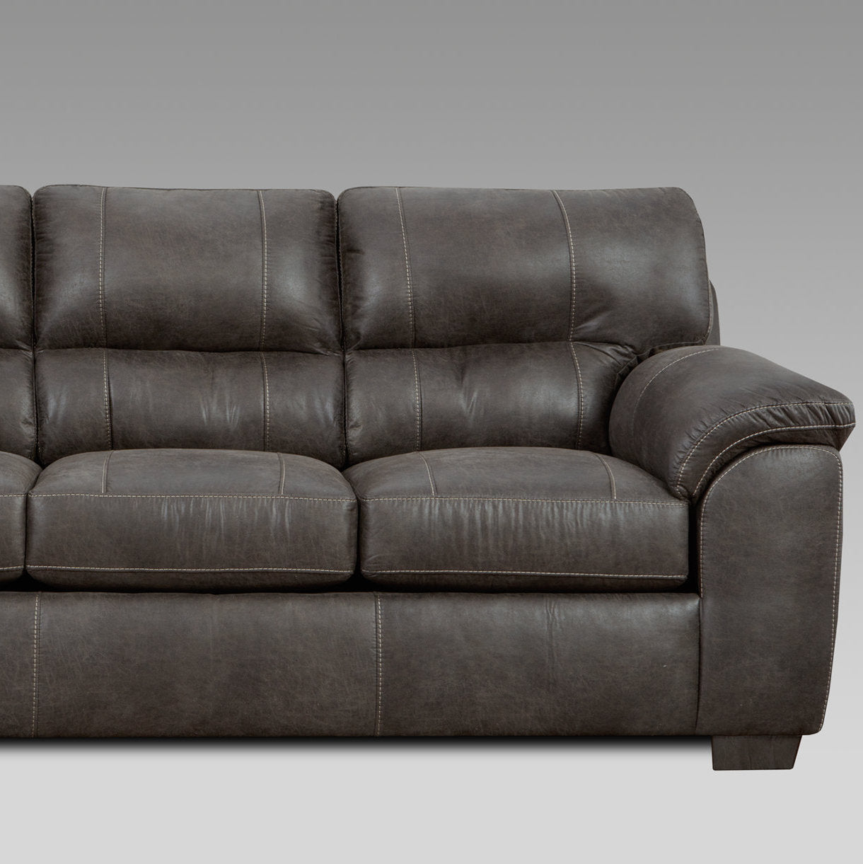 Tufted dark brown leather sofa with decorative stitching perfect for a modern living room