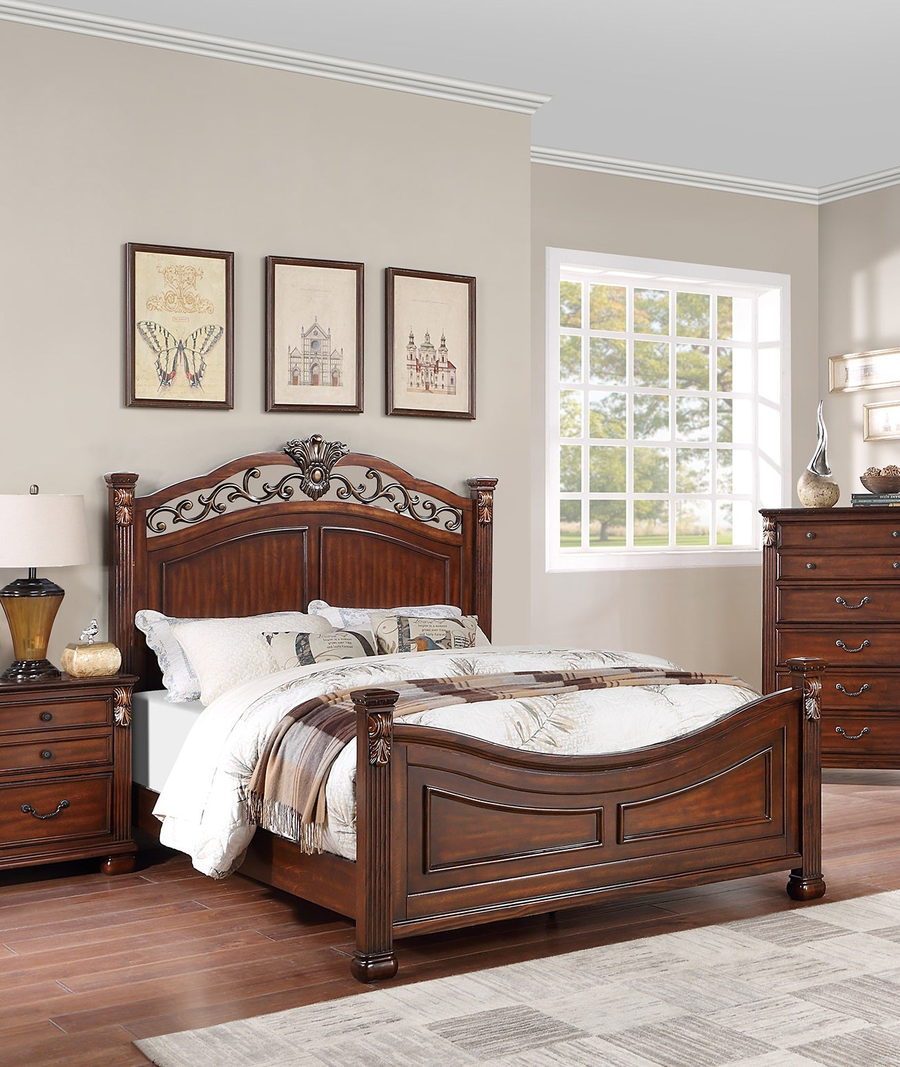 Ornate mahogany sleigh bed with detailed carvings and plush bedding