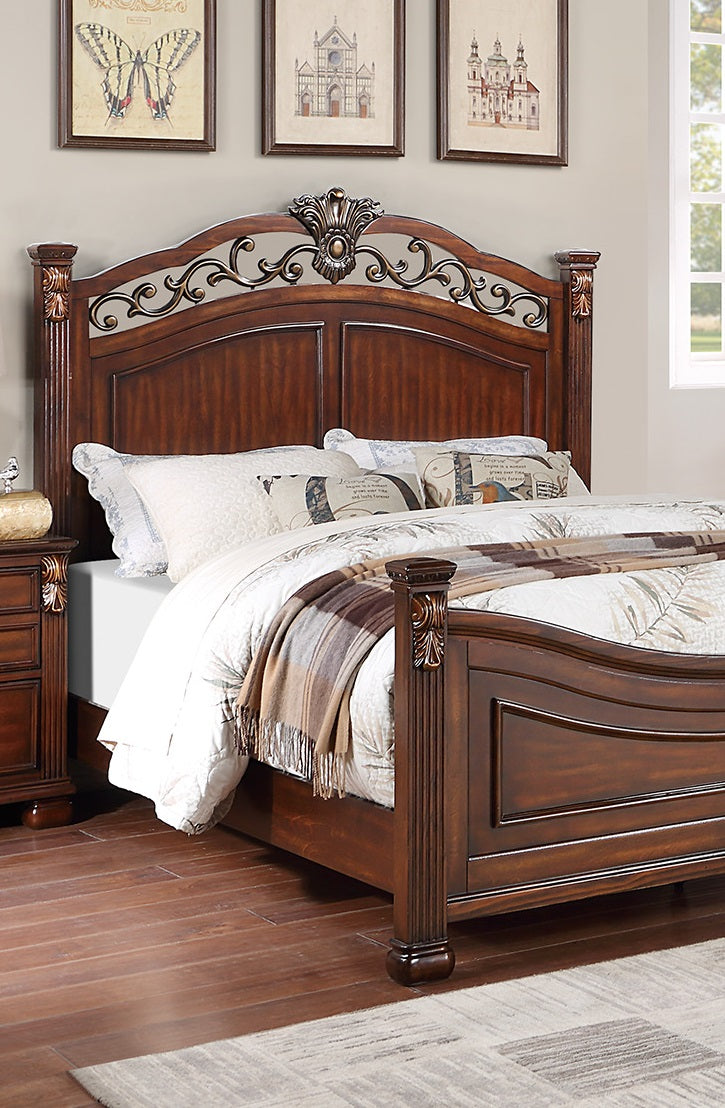 Ornate carved dark wood sleigh bed with ornate scrollwork on headboard