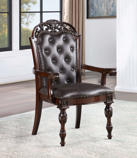 Dark brown tufted leather armchair with carved wooden accents and nailhead trim regal dining chair