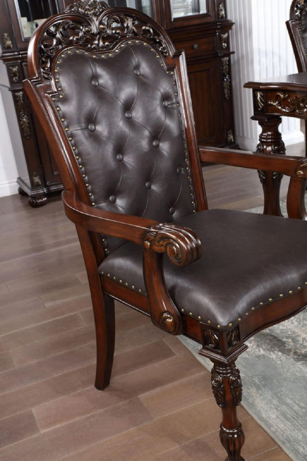 Dark brown tufted leather armchair with carved wooden frame and ornate details classic dining chair