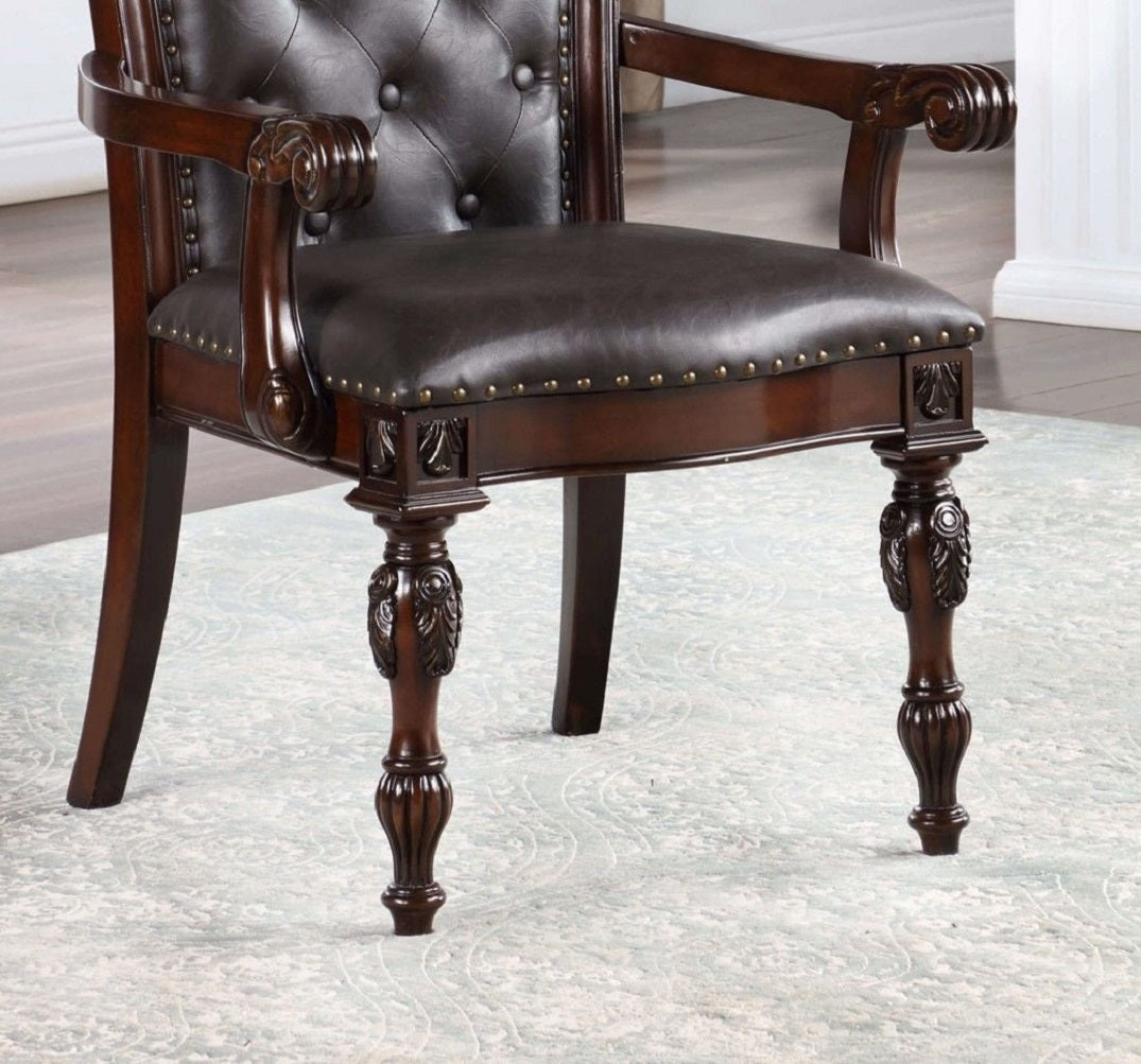 Dark brown leather armchair with tufted back and ornate dark wood legs