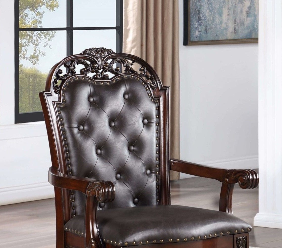 Ornate dark brown leather tufted armchair with polished wooden frame and carved details