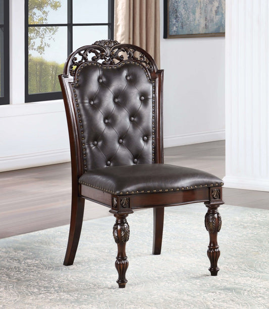 Dark brown tufted leather upholstered dining chair with ornate carved wood details and brass nailhead trim