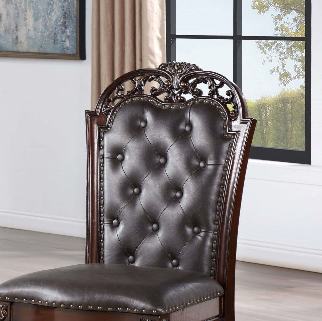 Ornate dark brown tufted leather dining chair with carved wood frame