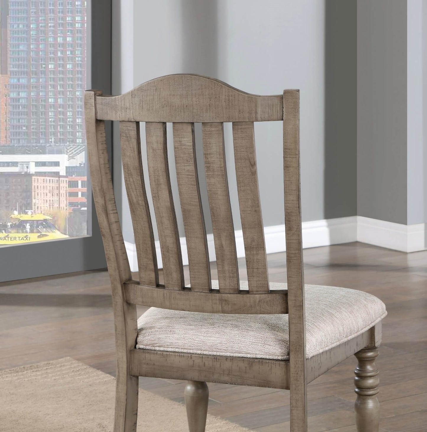 Distressed wood dining chair with woven upholstered seat in a neutral tone
