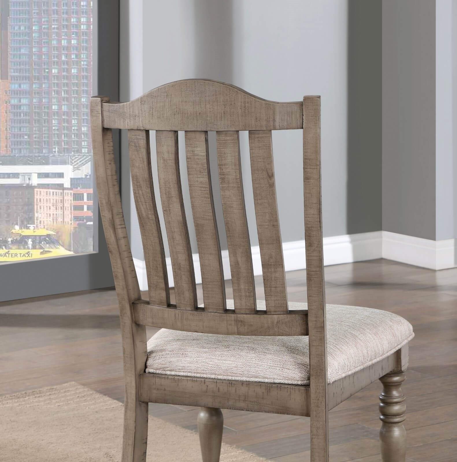 Distressed wood dining chair with woven upholstered seat in a neutral tone