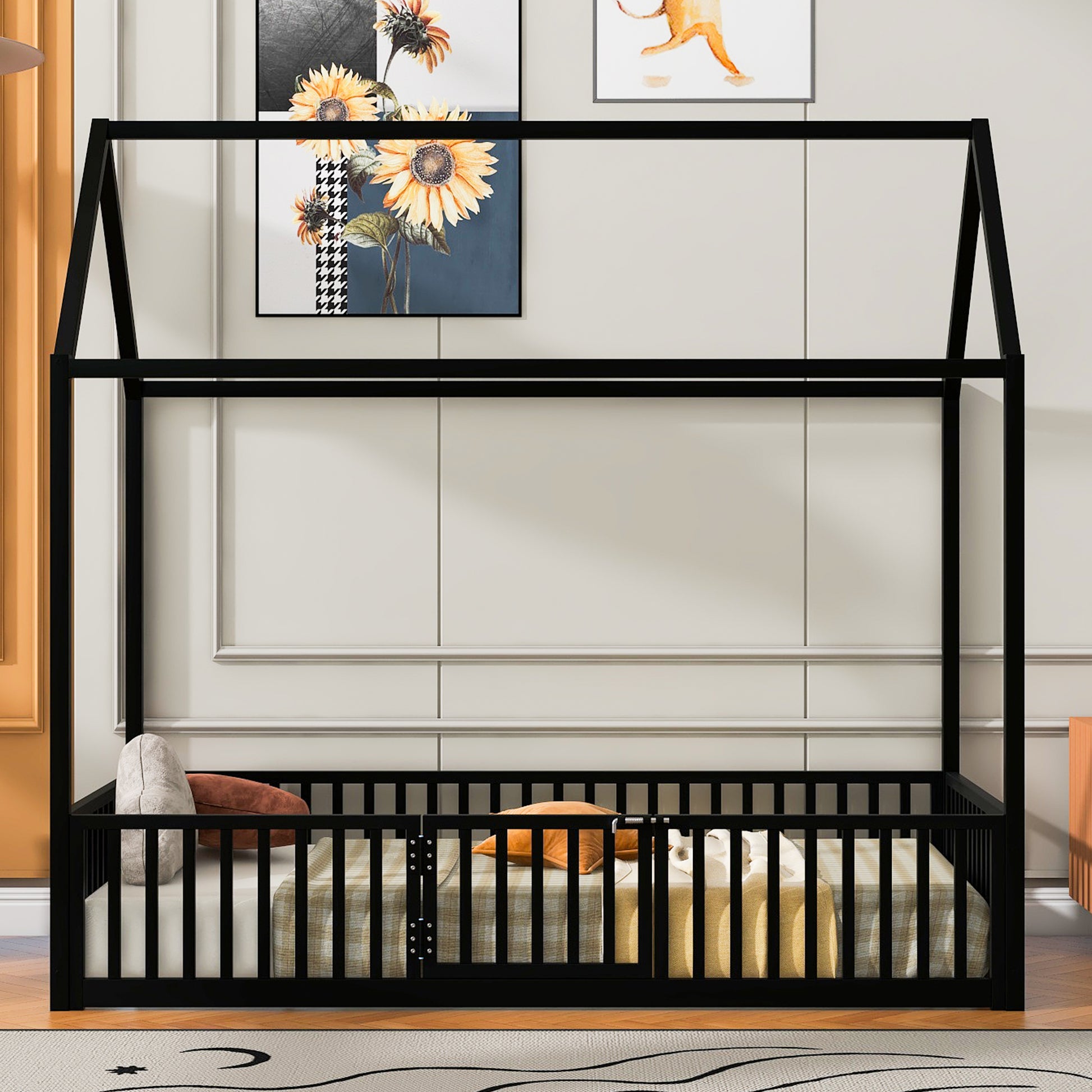 Black metal toddler house bed frame with safety rails and a mattress