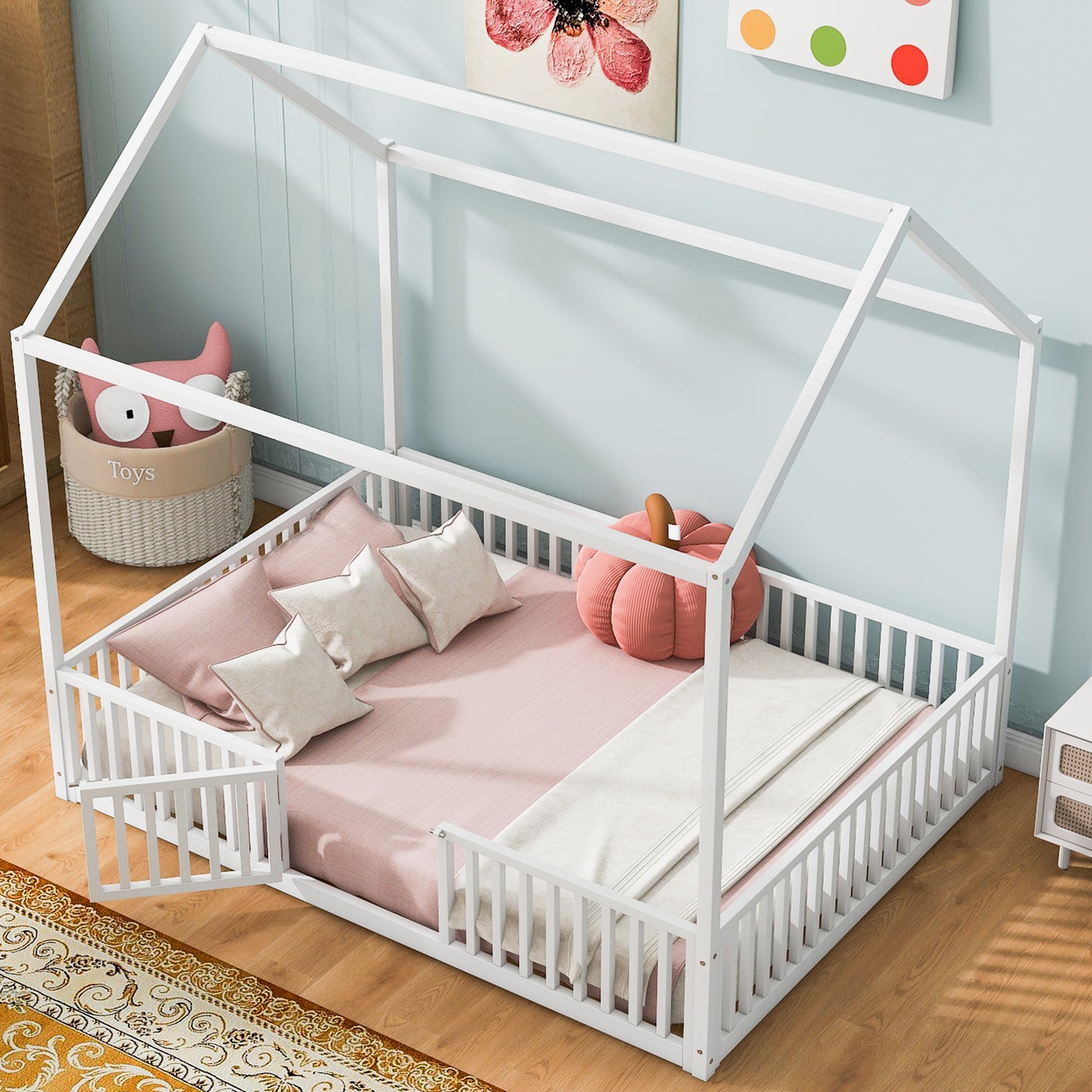 White wooden house bed frame with safety rails and pink bedding