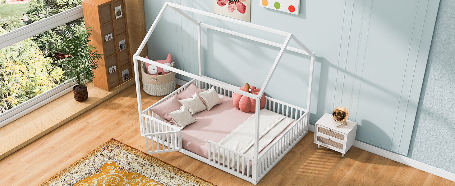 White wooden house bed frame with pink bedding and pillows