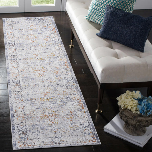 Distressed abstract runner rug with grey blue and orange hues on a dark wood floor