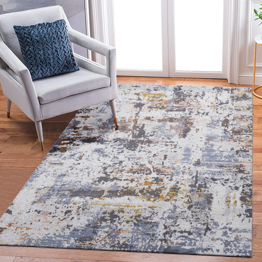 Abstract grey and blue area rug with hints of gold and rust texture