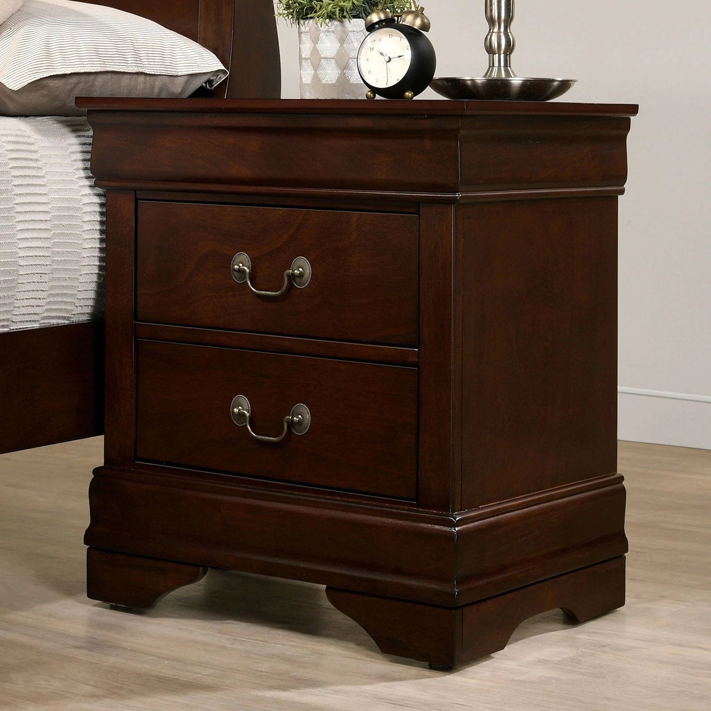 Dark wood twodrawer nightstand with ornate brass pulls