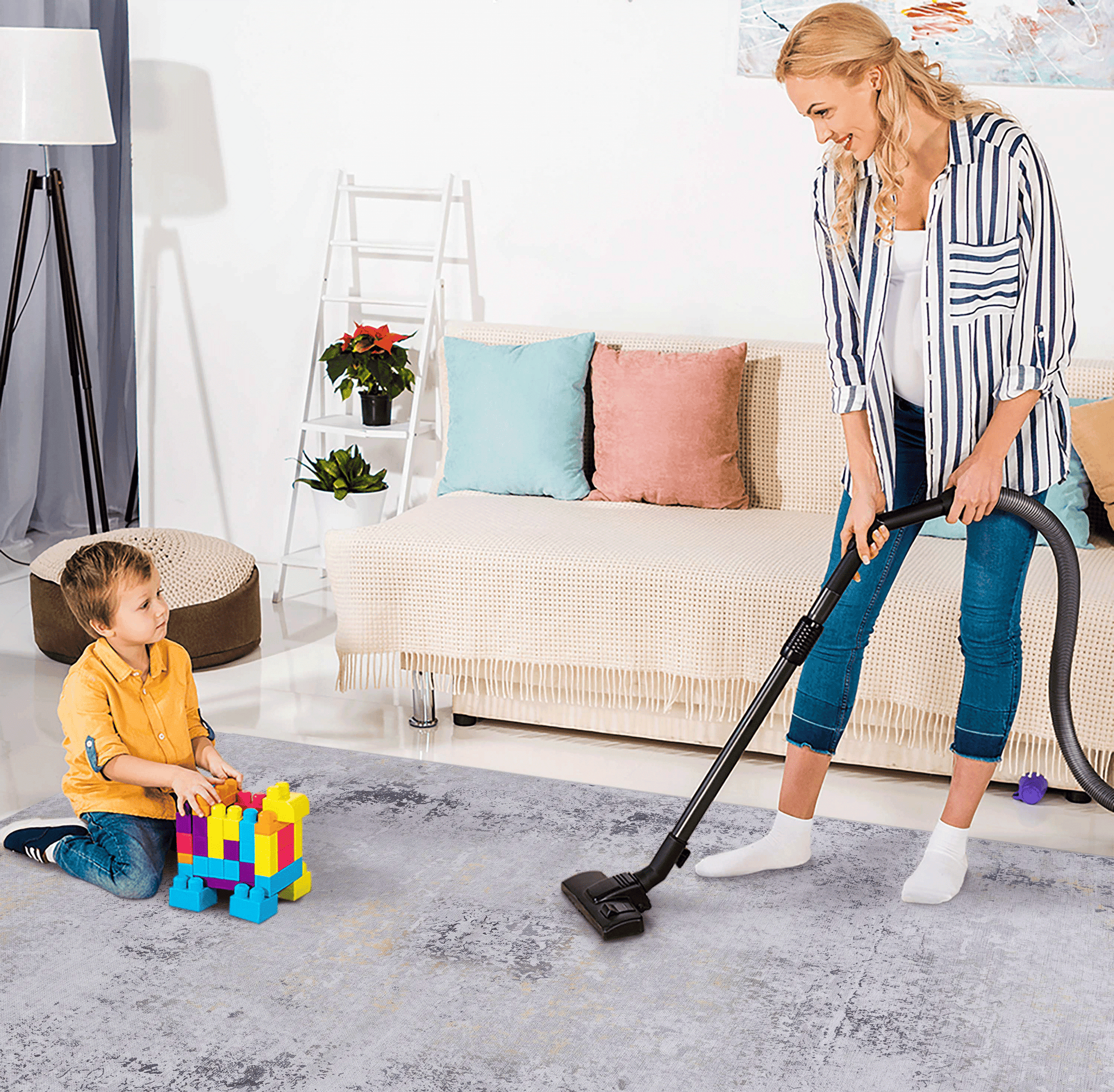 Woman vacuuming a distressed grey area rug with yellow and black accents
