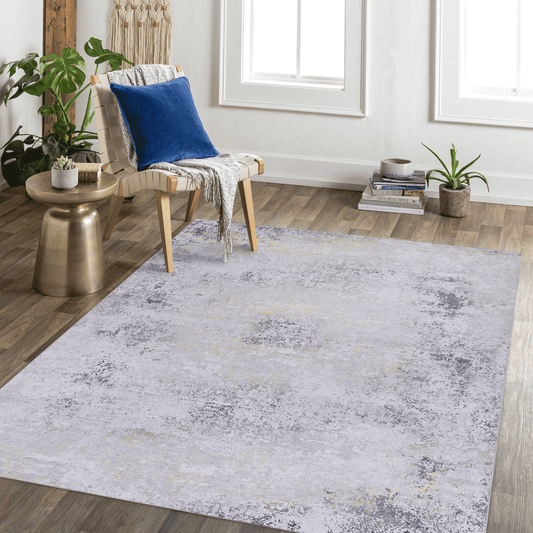 Abstract grey and gold area rug with distressed finish