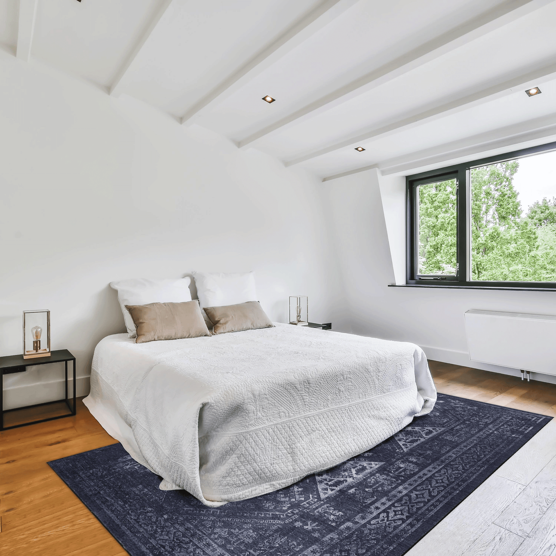 King size white textured duvet with two taupe throw pillows on a bed