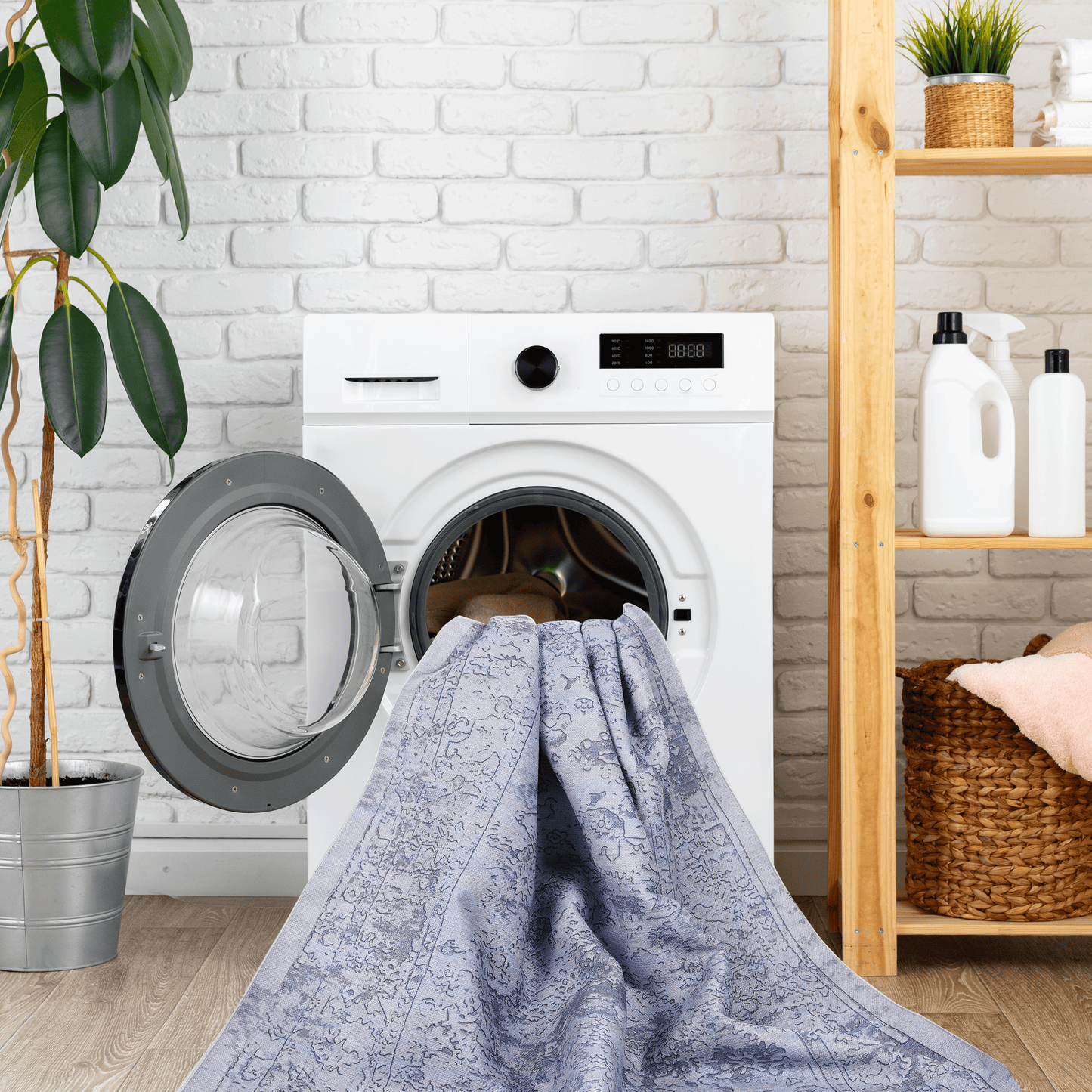 Blue vintage rug with intricate pattern partially inside washing machine