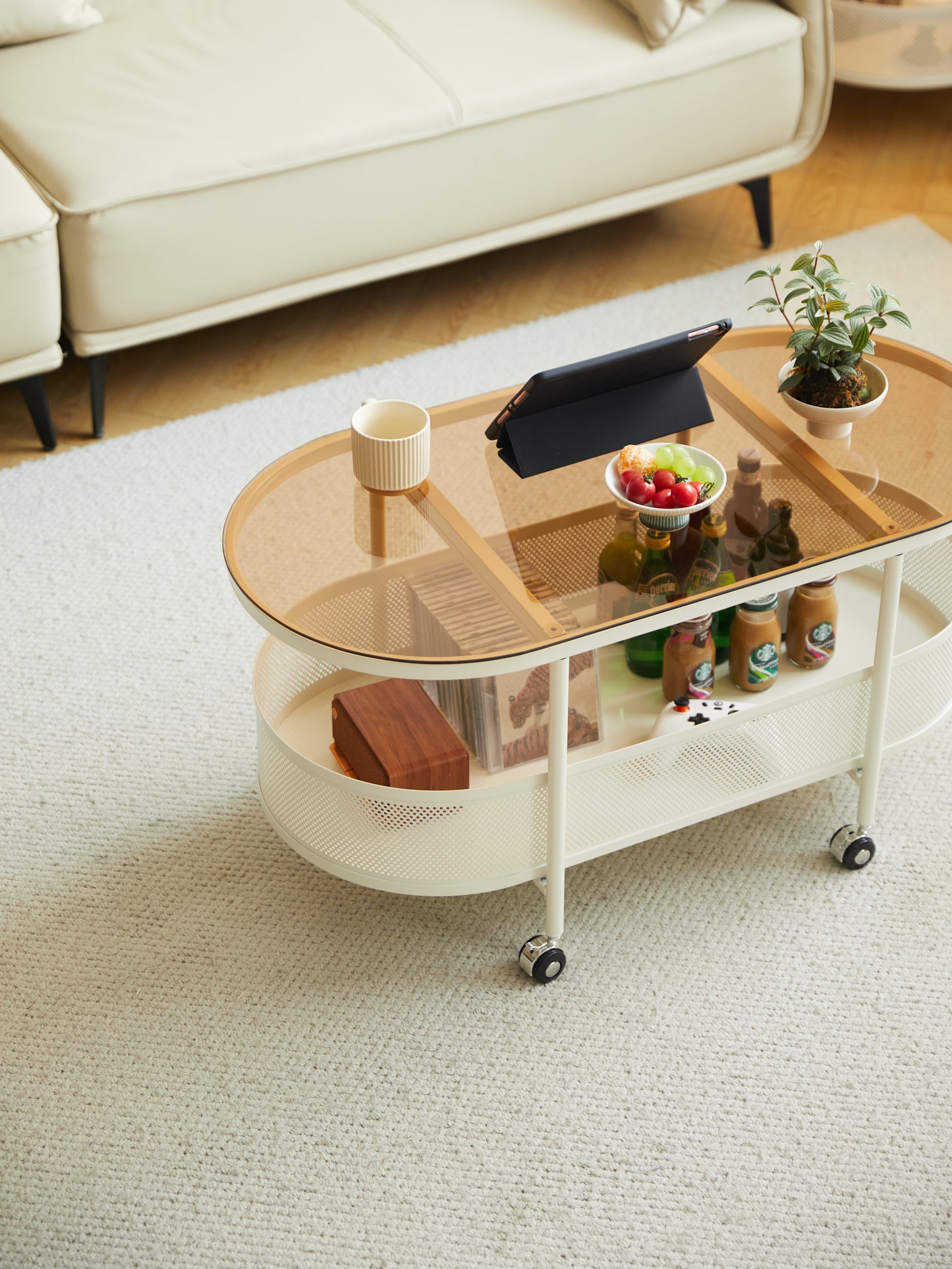 Oval glass top coffee table with cane detailing and wheels modern living room