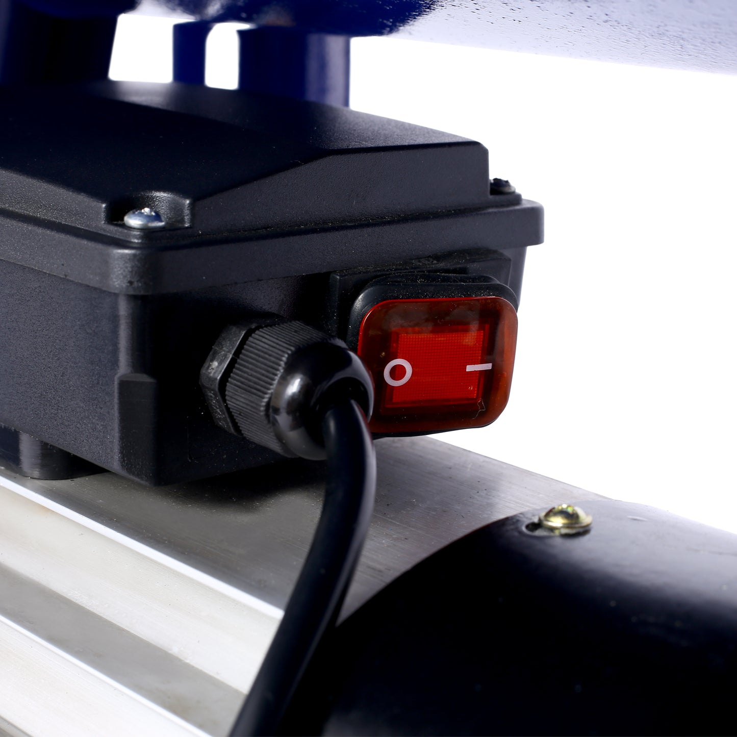 Closeup of a red power switch on a black electrical box for a submersible pump