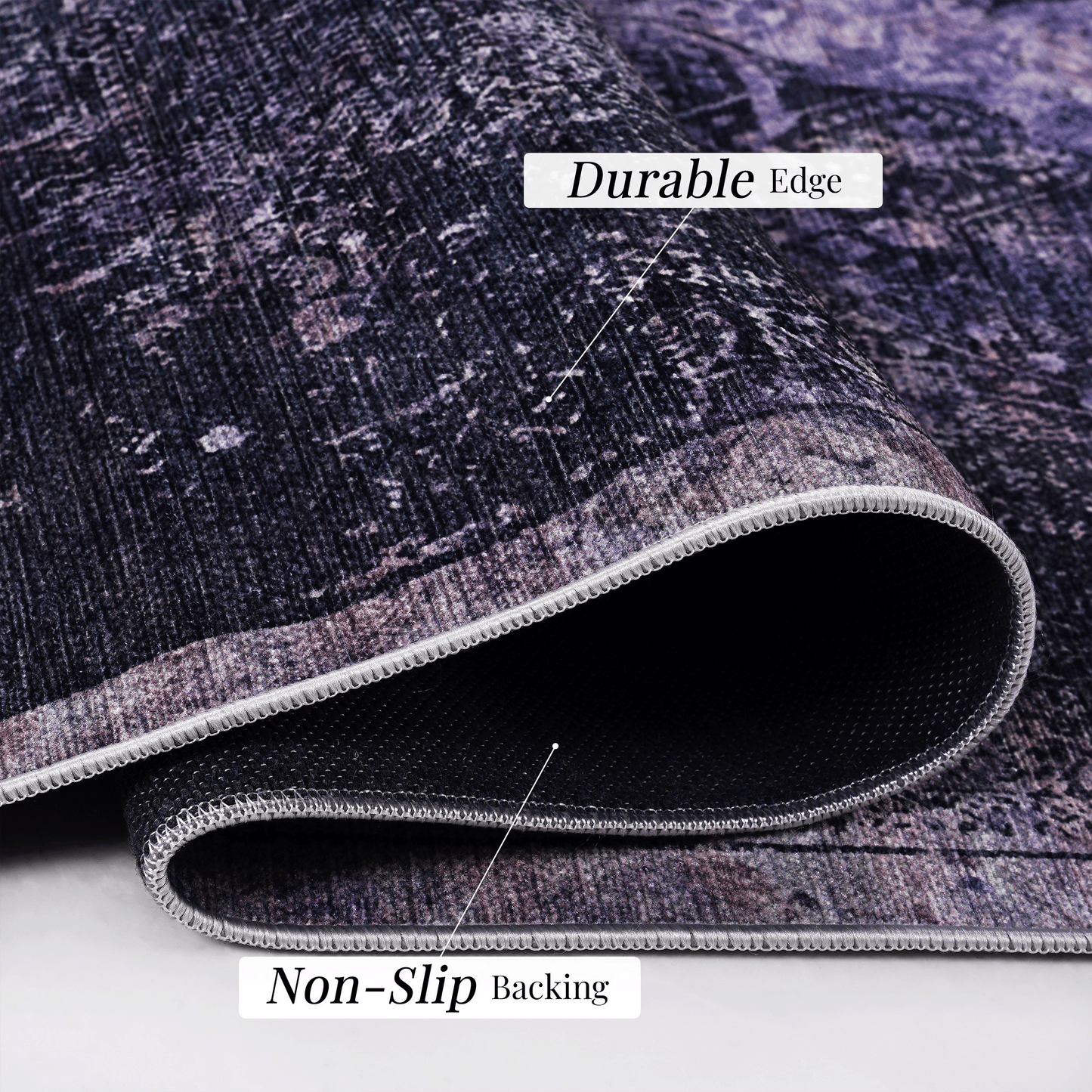 Closeup of a dark purple abstract pattern rug with a durable stitched edge and nonslip backing