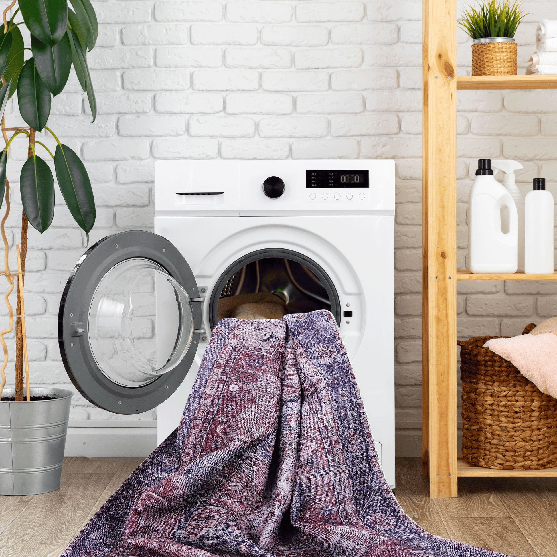 Intricately patterned Persian rug with deep reds and blues being loaded into a washing machine for cleaning